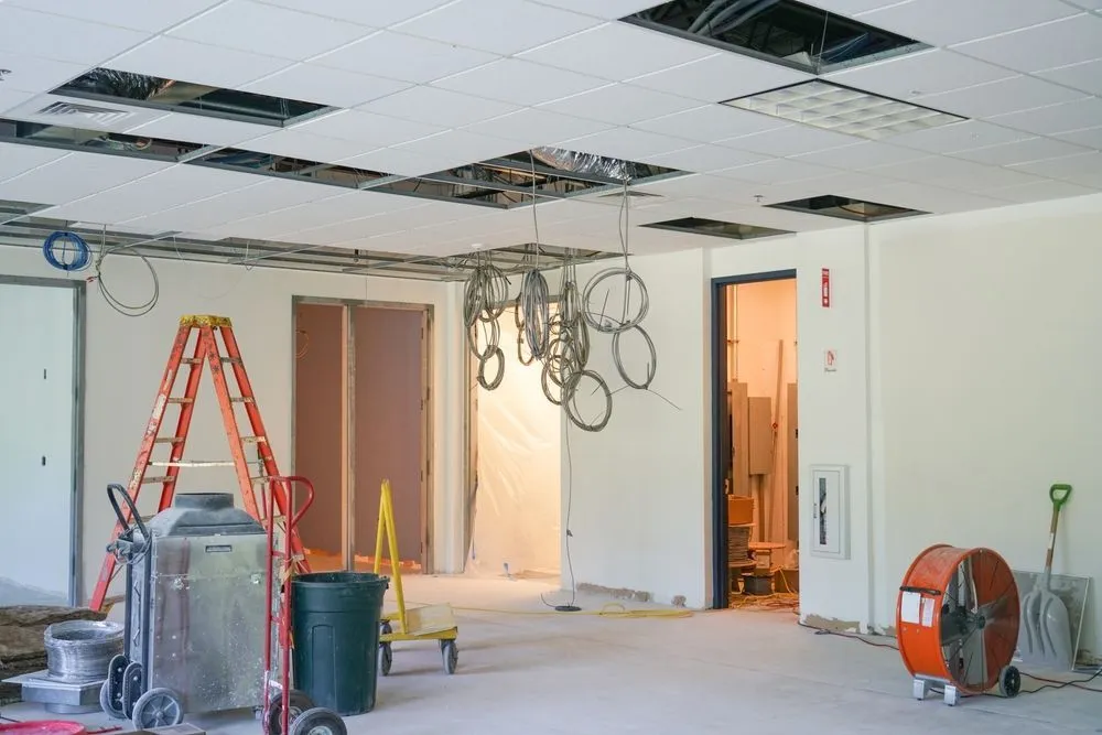 Commercial ceiling opened up for water damage restoration with drying equipment