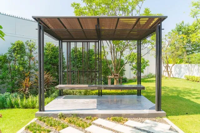Modern garden pavilion with a built-in bench on a concrete pad