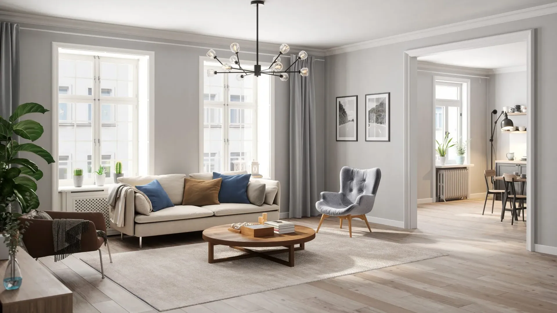 Staged living room with gray walls, a black chandelier, sofa and armchair