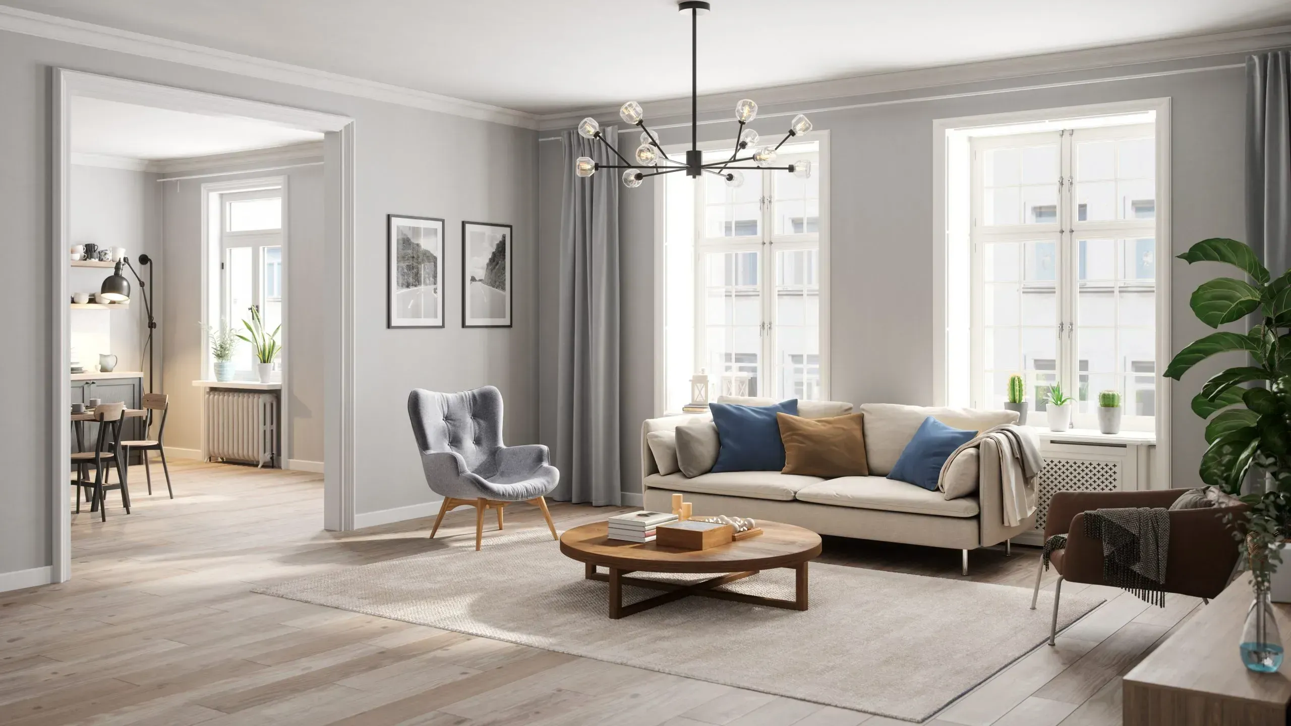 Staged living room with gray walls, a black chandelier, sofa and armchair